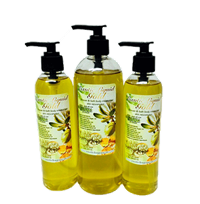 Three pump bottles of Exotic Liquid Gold body oil, filled with golden-yellow oil, with botanical labels, arranged against a black background.