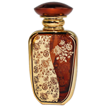 Spary bottle with a reflective gold metal body and rounded rectangular shape. The front features a  decorative panel with an intricate floral lattice pattern. The bottle has a gold atomizer spray and a gold cap.