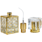 Square clear glass perfume spray bottles featuring an ornate gold pattern, gold collars, and clear acrylic block caps.