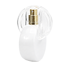 White circular glass spray bottles featuring distinctive plastic semi circular arched loop cap that curve over the spray nozzles, with gold sprayer.