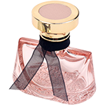Pink trapezoidal glass spray bottle featuring sweeping, curved shoulder that taper into a narrow neck, topped with a chunky gold circular pedestal cap.
