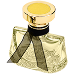 Yellow trapezoidal glass spray bottle featuring sweeping, curved shoulder that taper into a narrow neck, topped with a chunky gold circular pedestal cap.